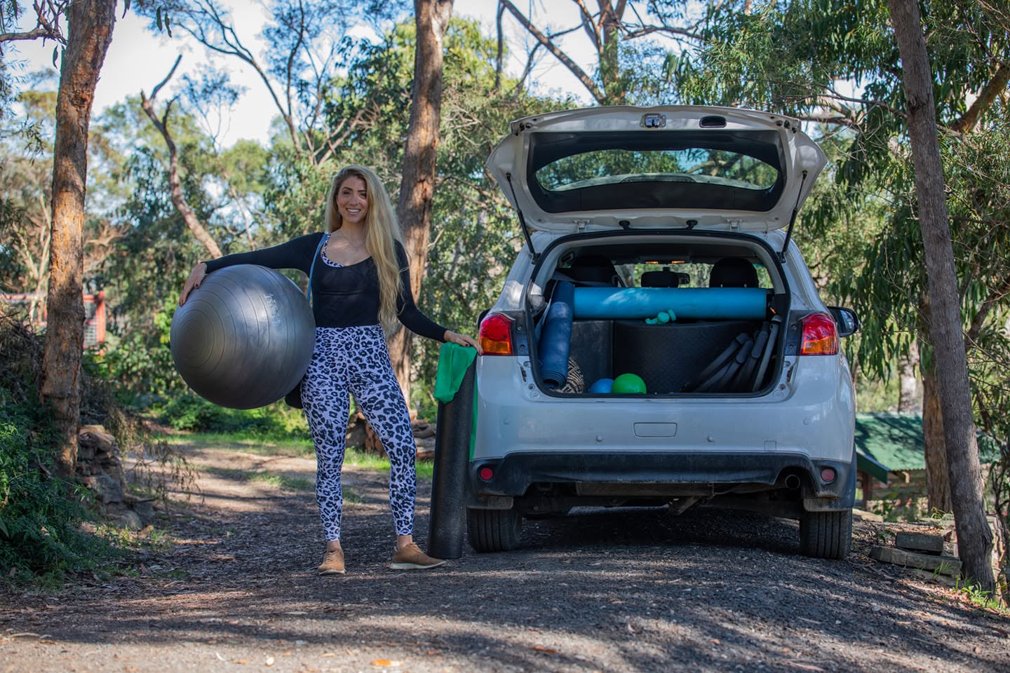 Lani with a car full of Pilates props
